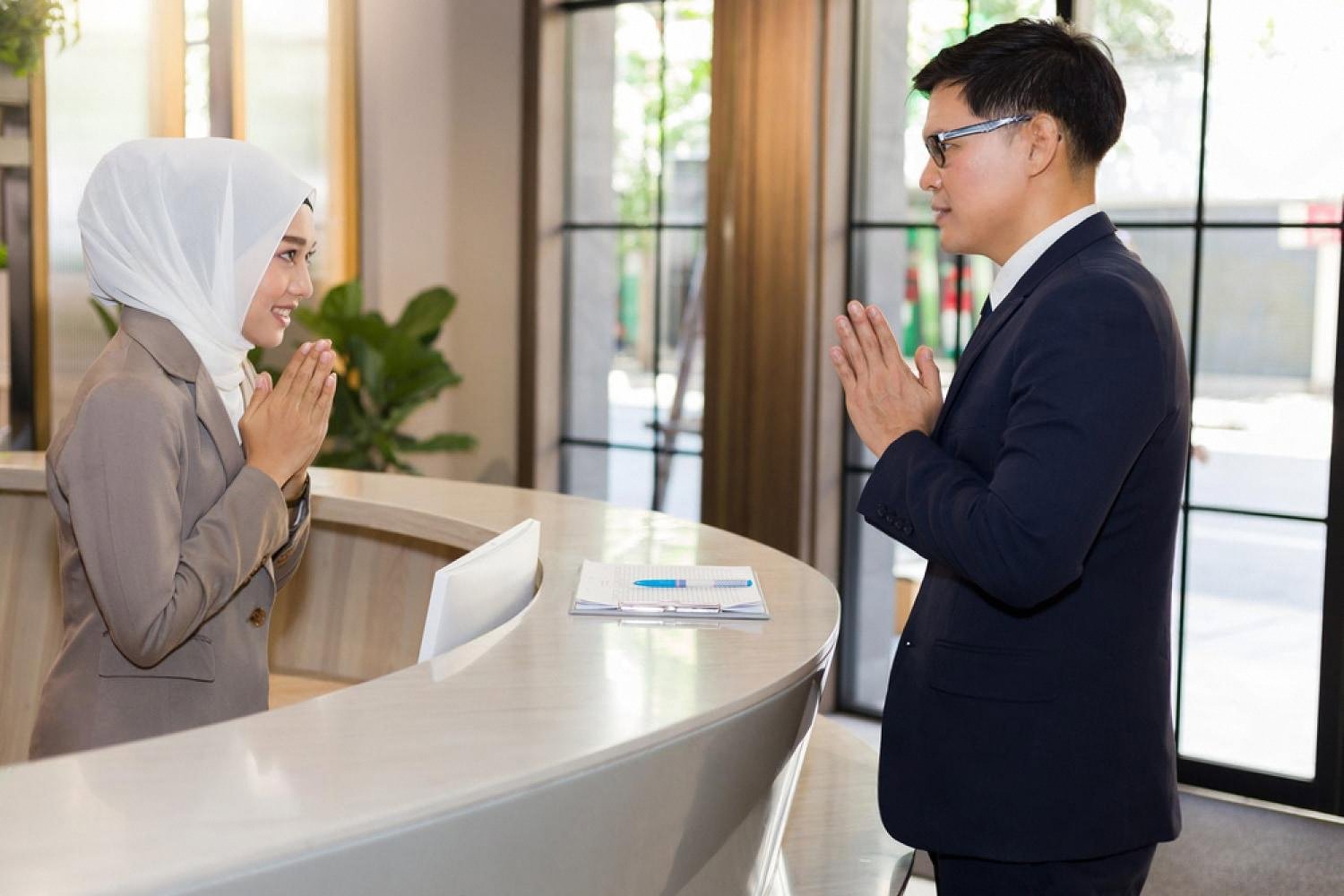 Compliance officer greeting a client at a Dubai reception desk during a due diligence review